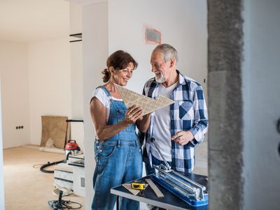 A couple review material for a home construction project.