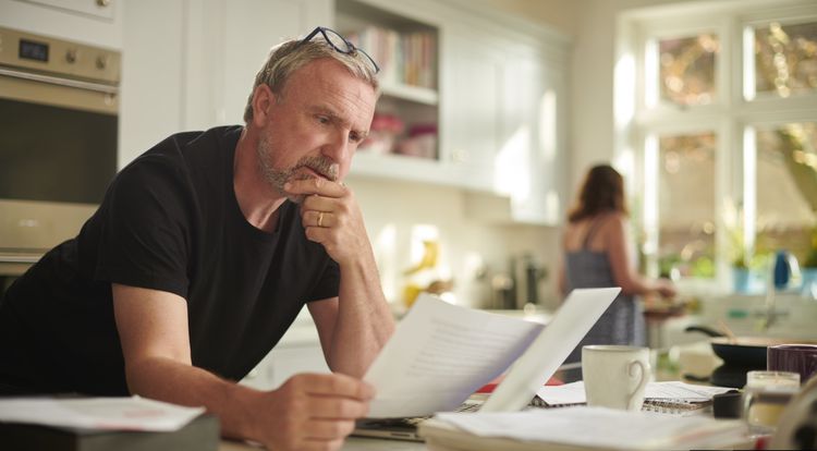 A middle-aged man sorts <a href=