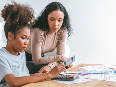 Mom teaching her daughter about finances.